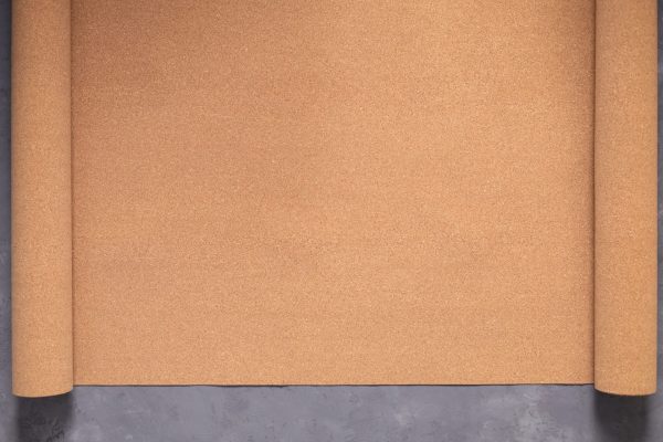 Roll of cork at cement floor background texture. Corkboard at wall